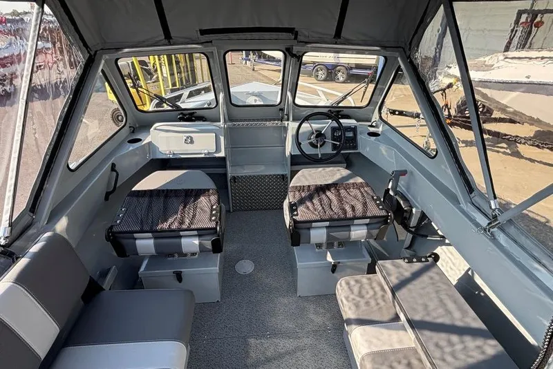 Slide: The Image of Interior of 2025 Hewescraft 180 Sportsman boat, featuring seating and steering console. - 4
