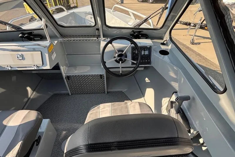 Slide: The Image of Interior of 2025 Hewescraft 180 Sportsman boat with steering wheel and seating. - 5