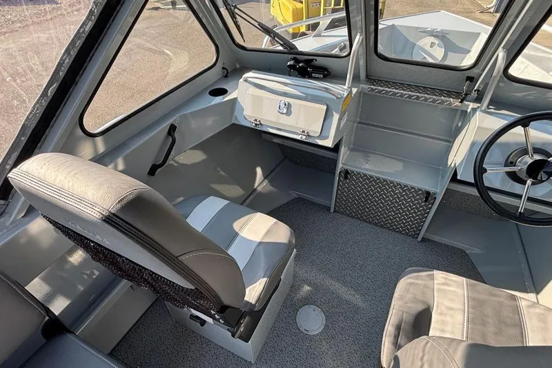 Slide: The Image of Interior of 2025 Hewescraft 180 Sportsman boat with seating and steering wheel. - 6