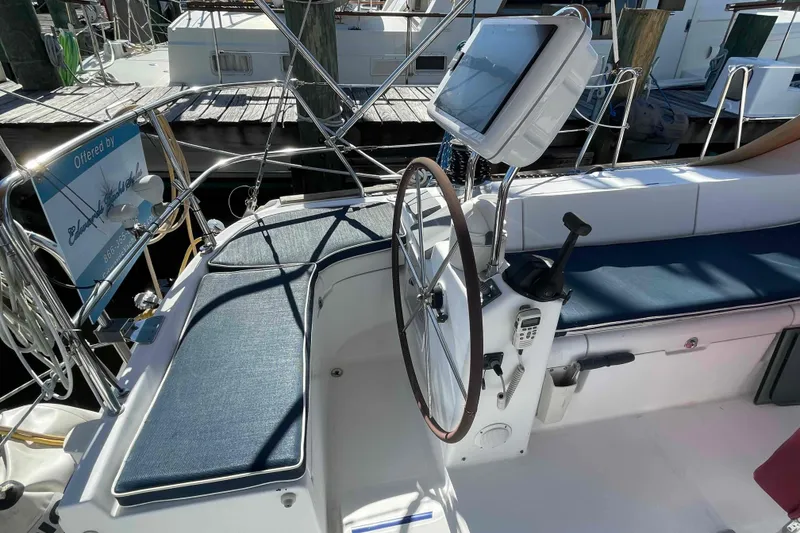 Slide: The Image of Cockpit of 2004 Beneteau Oceanis 473 sailboat with steering wheel and navigation equipment. - 102