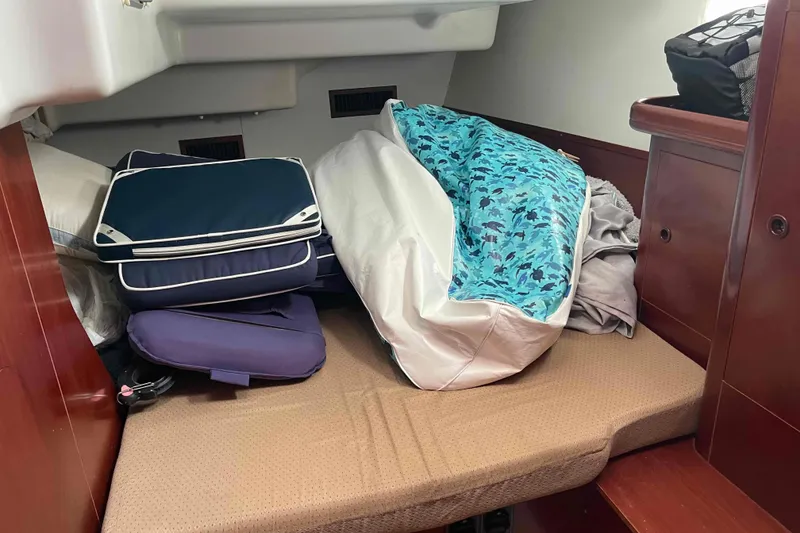 Slide: The Image of Interior cabin of 2004 Beneteau Oceanis 473 with cushions and bedding. - 106