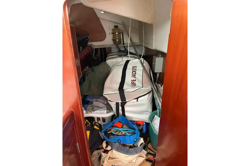 Slide: The Image of Storage area on a 2004 Beneteau Oceanis 473 sailboat with life jackets and equipment. - 25