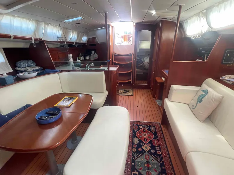 Slide: The Image of Interior of 2004 Beneteau Oceanis 473 yacht with elegant wood finish and cozy seating. - 27