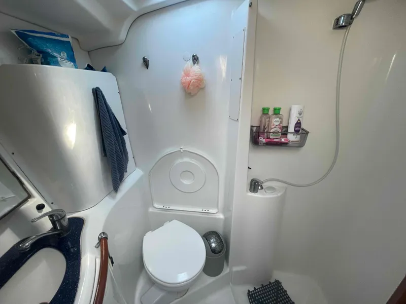 Slide: The Image of Bathroom interior of 2004 Beneteau Oceanis 473 yacht, featuring toilet and shower amenities. - 30