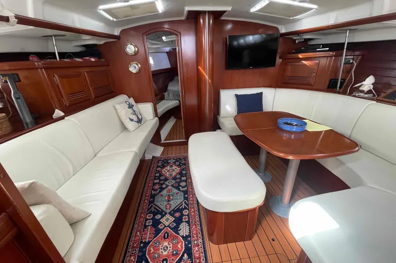 Slide: The Image of Luxurious interior of 2004 Beneteau Oceanis 473 yacht with elegant seating and wooden finishes. - 31