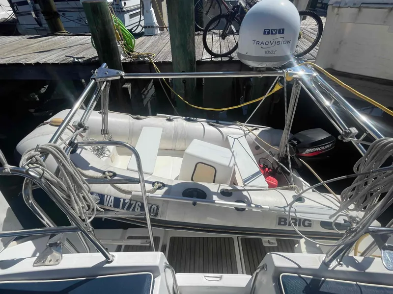 Slide: The Image of Beneteau Oceanis 473 sailboat with dinghy and outboard motor docked at marina, 2004 model. - 37