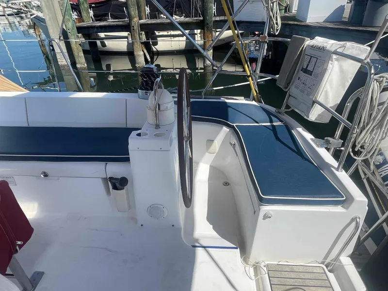 Slide: The Image of 2004 Beneteau Oceanis 473 sailboat cockpit with blue seating and steering wheel. - 45