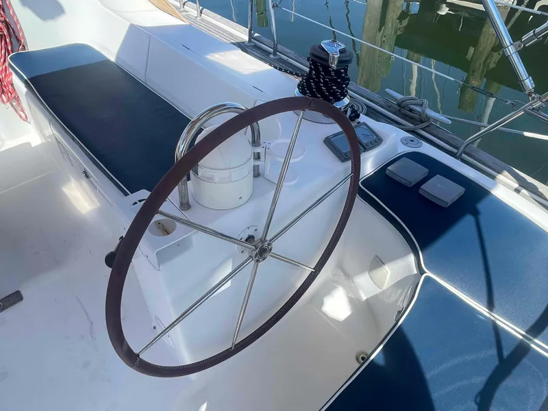 Slide: The Image of Steering wheel of a 2004 Beneteau Oceanis 473 sailboat, featuring a sleek cockpit design. - 46