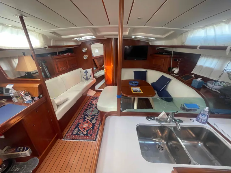 Slide: The Image of Interior of 2004 Beneteau Oceanis 473 yacht, featuring cozy seating and modern amenities. - 6