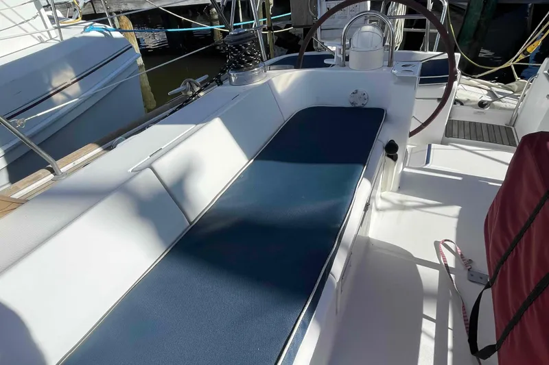Slide: The Image of Cockpit of 2004 Beneteau Oceanis 473 sailboat with blue seating and steering wheel. - 85