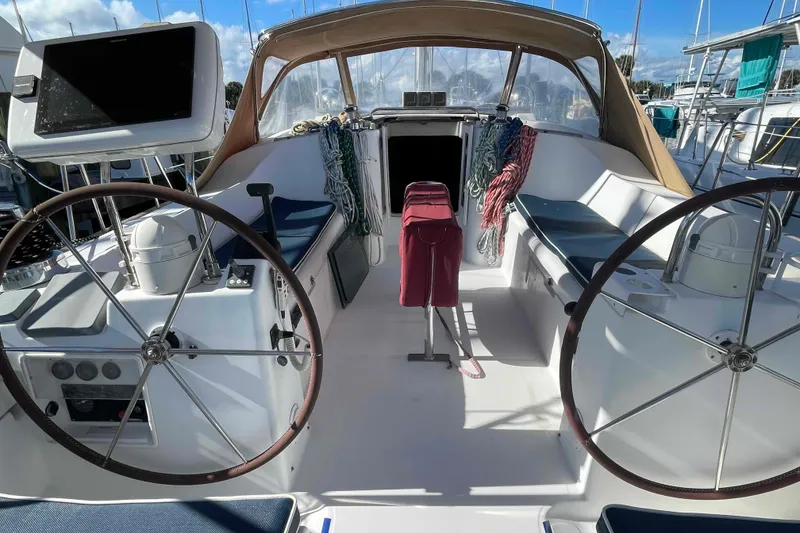 Slide: The Image of 2004 Beneteau Oceanis 473 cockpit with dual steering wheels and navigation equipment. - 86