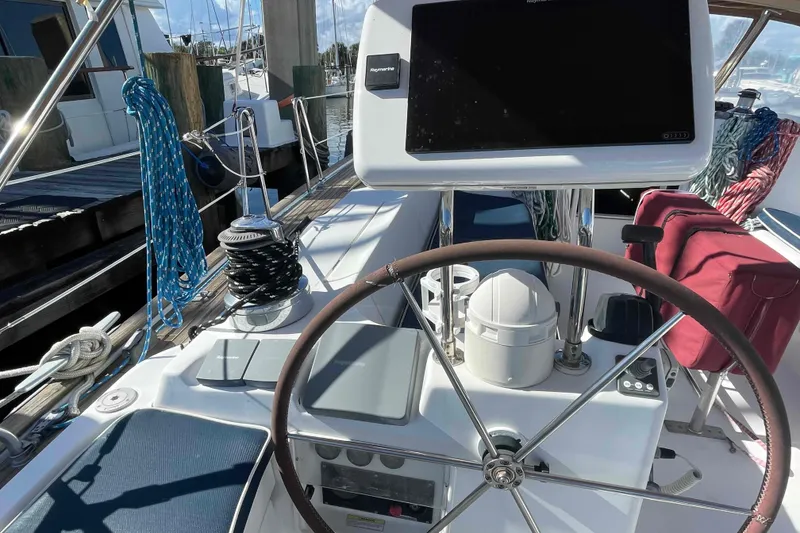 Slide: The Image of Cockpit of 2004 Beneteau Oceanis 473 sailboat with steering wheel and navigation equipment. - 87