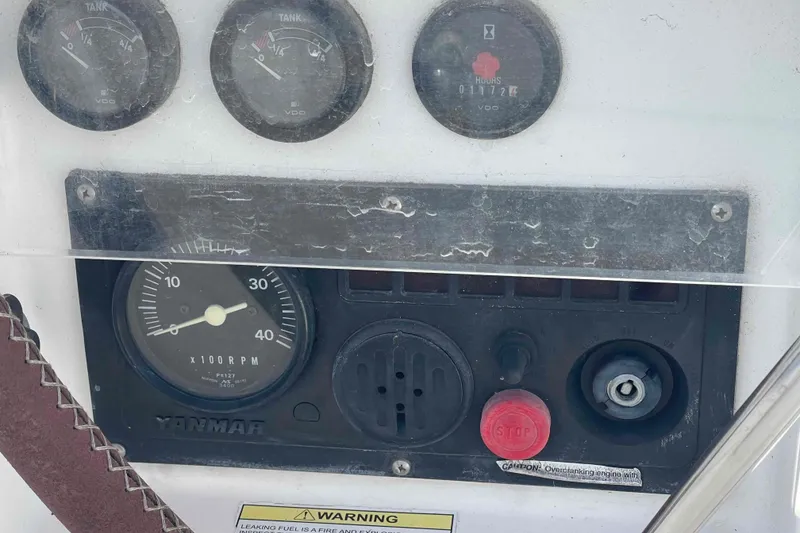 Slide: The Image of Control panel of a 2004 Beneteau Oceanis 473 sailboat with gauges and warning labels. - 89