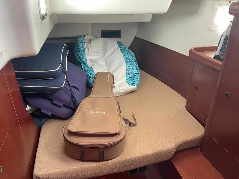 Slide: The Image of Cozy cabin interior of 2004 Beneteau Oceanis 473 with guitar case and cushions. - 9