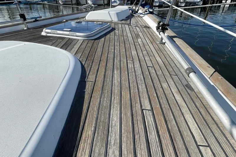 Slide: The Image of Deck of 2004 Beneteau Oceanis 473 sailboat with wooden finish and hatch. - 98