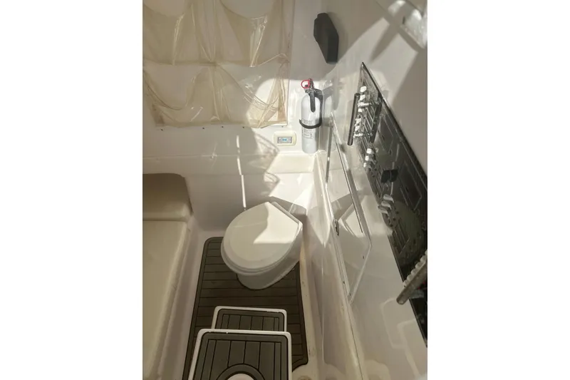 Slide: The Image of Interior of 2017 Sea Hunter 39 boat featuring a compact marine toilet setup. - 15