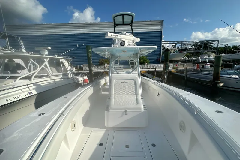 Slide: The Image of 2017 Sea Hunter 39 boat docked, featuring spacious deck and modern navigation equipment. - 16