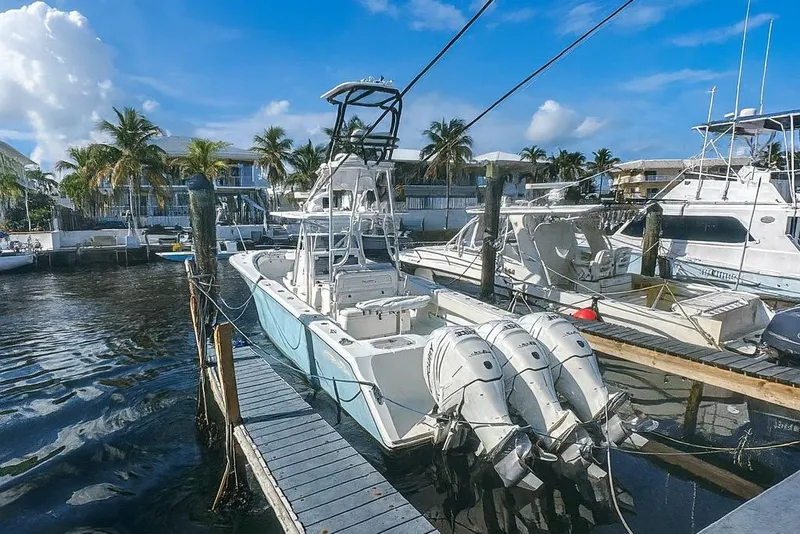Slide: The Image of 2017 Sea Hunter 39 boat docked at marina with triple outboard engines. - 3