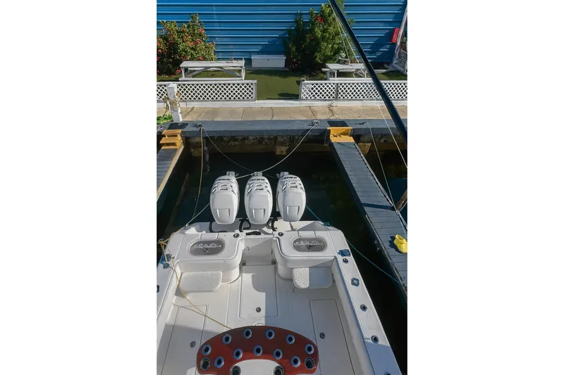 Slide: The Image of 2017 Sea Hunter 39 boat docked with triple outboard engines, viewed from above. - 4