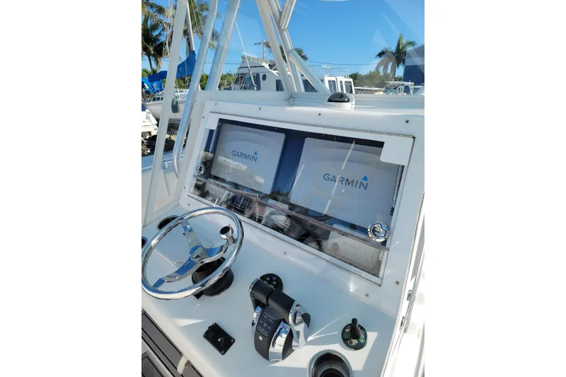 Slide: The Image of 2017 Sea Hunter 39 boat dashboard with Garmin navigation system and steering wheel. - 7