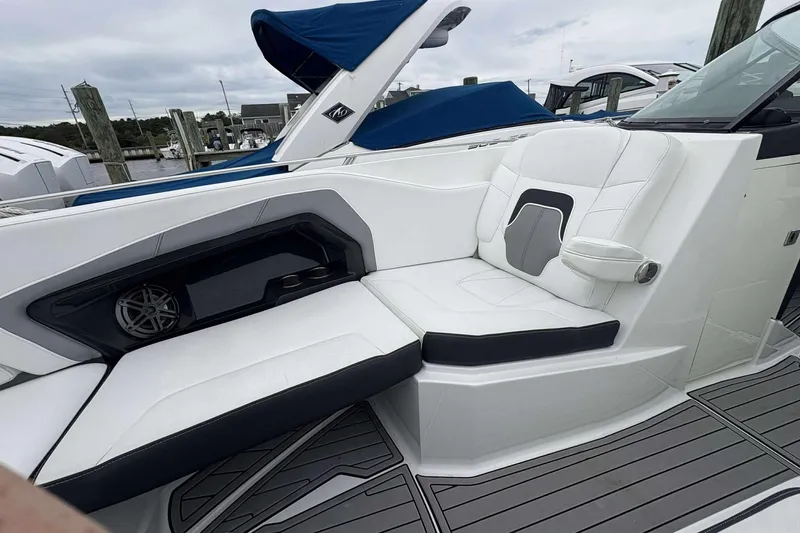 Slide: The Image of Luxurious seating on a 2016 Monterey 298SS Super Sport boat, featuring sleek white upholstery. - 11