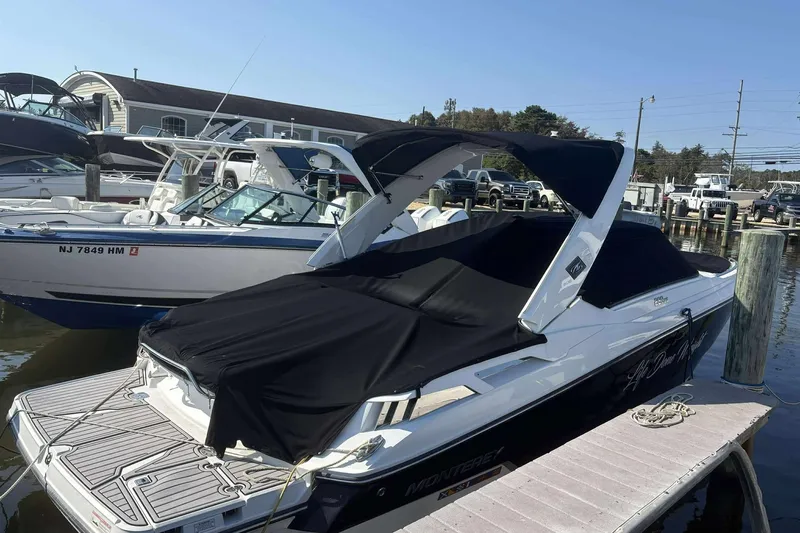 Slide: The Image of 2016 Monterey 298SS Super Sport boat docked with black covers, sunny marina setting. - 3