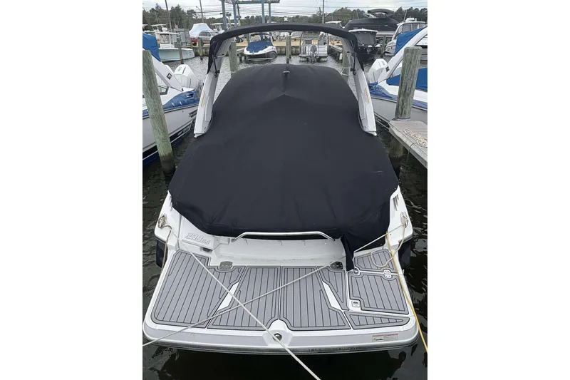 Slide: The Image of 2016 Monterey 298SS Super Sport boat docked with black cover, rear view. - 4
