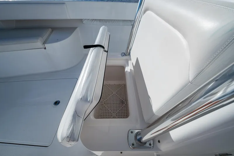 Slide: The Image of 2011 Bahama 37 boat interior with white seating and storage compartment. - 10