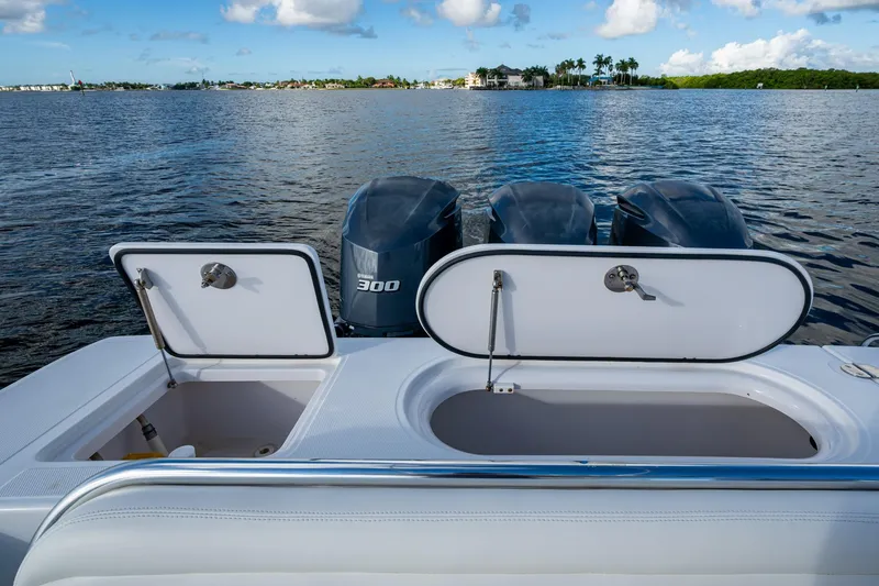 Slide: The Image of 2011 Bahama 37 boat with open storage compartments and triple Yamaha 300 engines. - 17