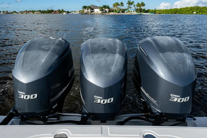 Slide: The Image of Triple Yamaha 300 outboard engines on a 2011 Bahama 37 boat, cruising on a scenic waterway. - 19