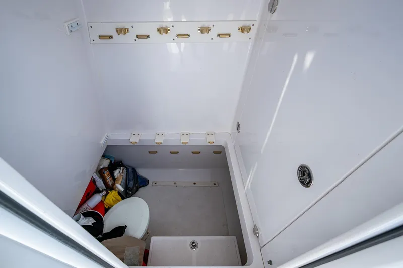 Slide: The Image of Storage compartment in a 2011 Bahama 37 boat, featuring organized shelves and various items. - 21