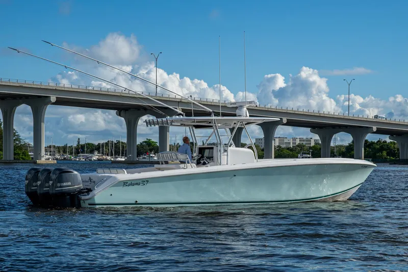 Slide: The Image of 2011 Bahama 37 boat on water near bridge, clear sky background. - 24