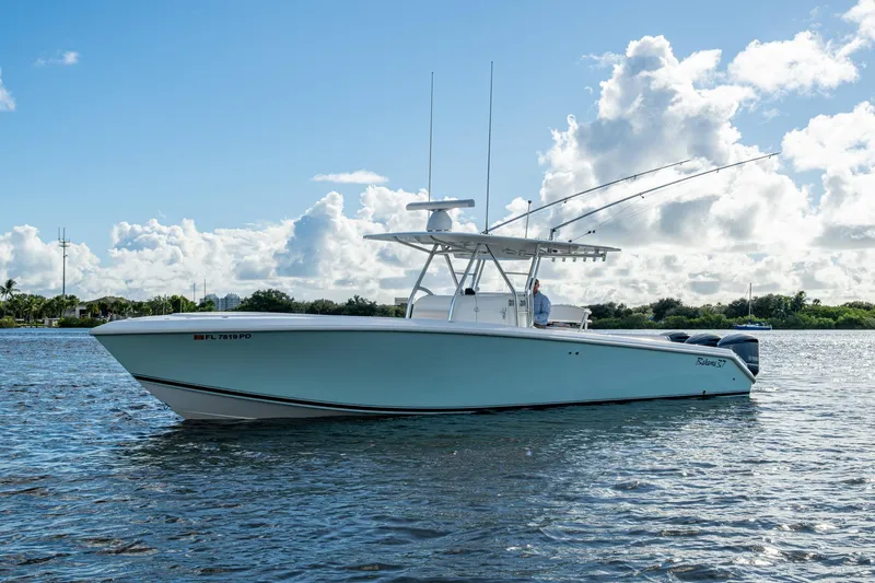 Slide: The Image of 2011 Bahama 37 boat on water under blue sky with clouds. - 25