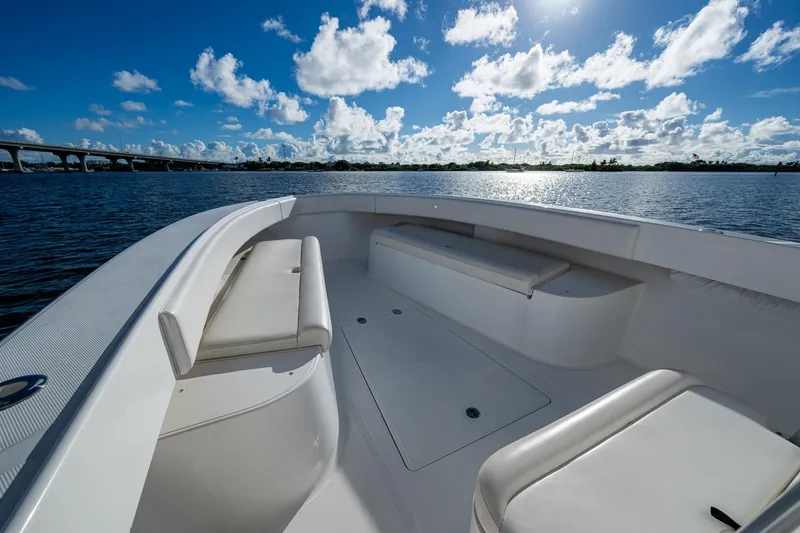 Slide: The Image of 2011 Bahama 37 boat interior with seating, on a sunny day by the water. - 5