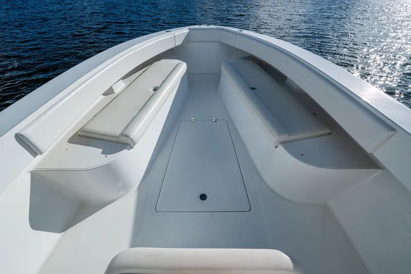 Slide: The Image of 2011 Bahama 37 boat interior with cushioned seating, on calm water. - 6