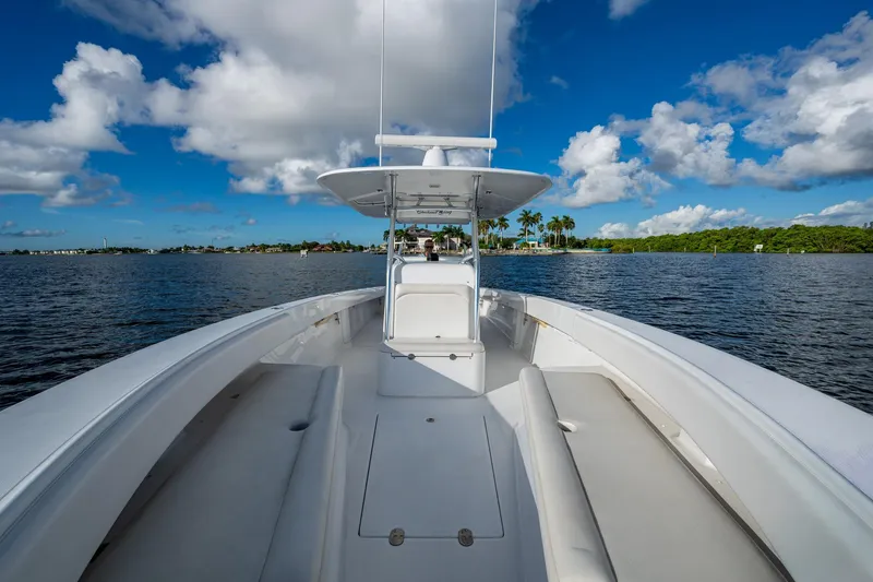 Slide: The Image of 2011 Bahama 37 boat cruising on a sunny day with blue skies and clouds. - 8