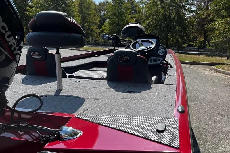 Slide: The Image of 2026 Ranger RT178 boat interior with red accents and seating, parked outdoors. - 5