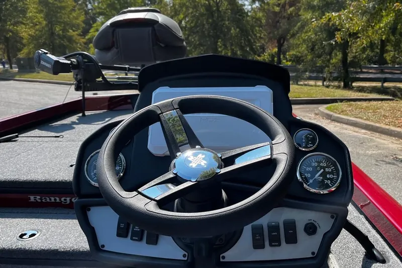 Slide: The Image of 2026 Ranger RT178 boat dashboard with steering wheel and gauges in a sunny outdoor setting. - 6