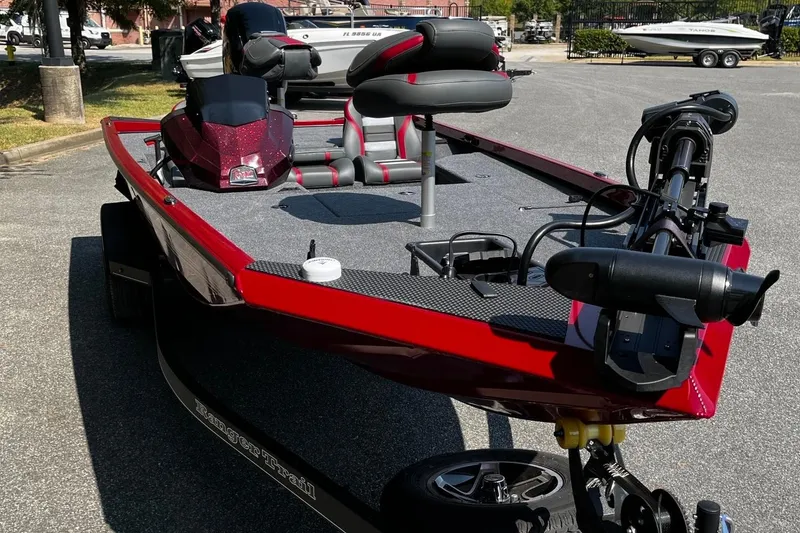 Slide: The Image of 2026 Ranger RT178 boat in vibrant red, parked outdoors with modern features. - 7
