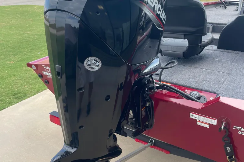 Slide: The Image of 2022 Tracker Pro Team 175 TXW boat with Mercury outboard motor, red hull, and gray interior. - 10