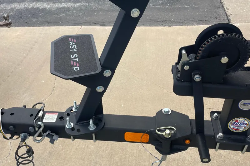 Slide: The Image of 2022 Tracker Pro Team 175 TXW trailer with Easy Step feature on concrete surface. - 11