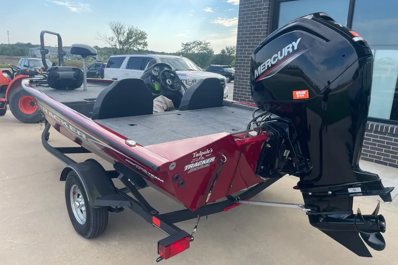 Slide: The Image of 2022 Tracker Pro Team 175 TXW boat with Mercury engine, parked outdoors. - 2