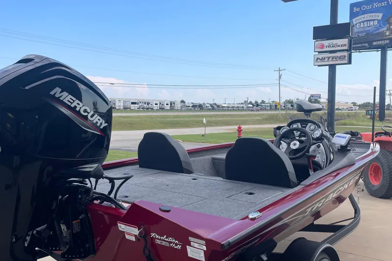 Slide: The Image of 2022 Tracker Pro Team 175 TXW boat with Mercury engine, parked outdoors. - 3