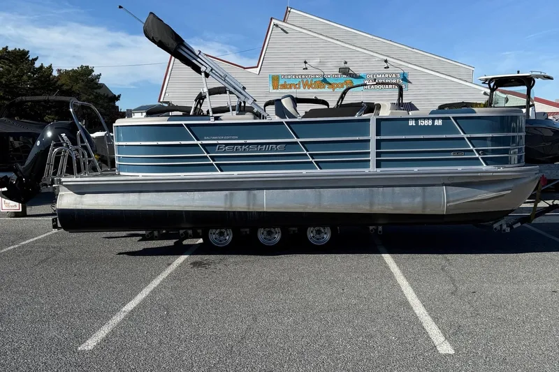 The Image of 2025 Berkshire 22RFX LE 2.75 pontoon boat in parking lot, side view. - 11