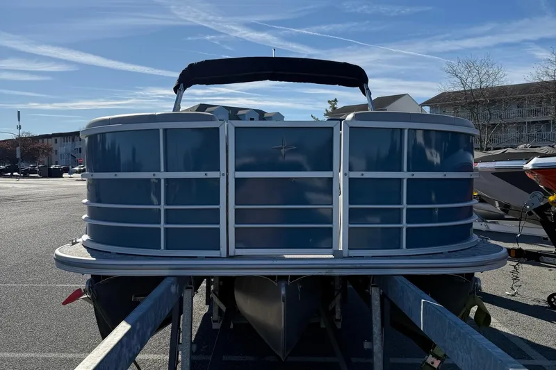 Slide: The Image of 2025 Berkshire 22RFX LE 2.75 pontoon boat on trailer, parked outdoors. - 13