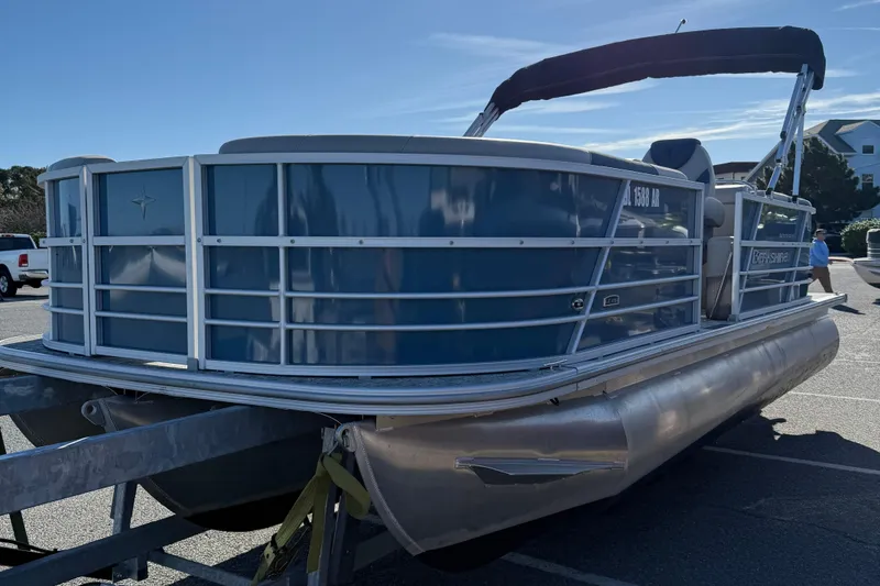 Slide: The Image of 2025 Berkshire 22RFX LE 2.75 pontoon boat on trailer in parking lot. - 14