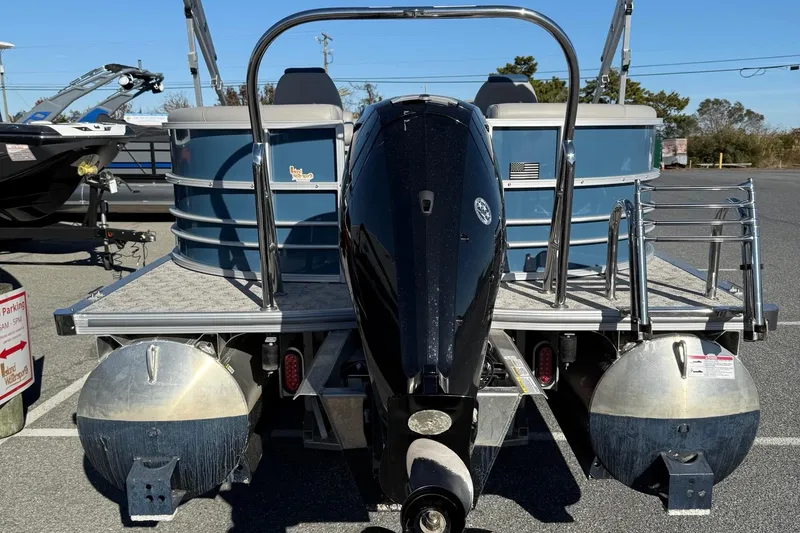 Slide: The Image of 2025 Berkshire 22RFX LE 2.75 pontoon boat, rear view with motor and ladder. - 17