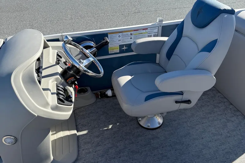 Slide: The Image of Captain's chair and helm of 2025 Berkshire 22RFX LE 2.75 pontoon boat. - 22