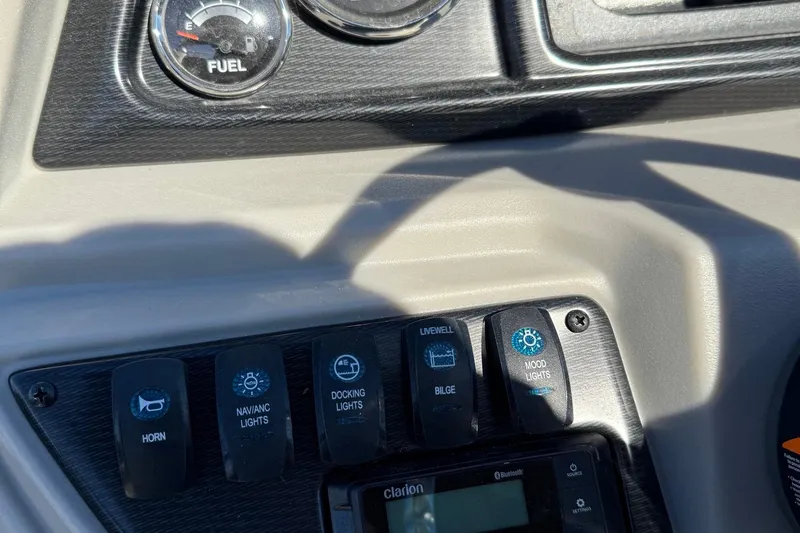 Slide: The Image of Control panel of 2025 Berkshire 22RFX LE 2.75 with fuel gauge and light switches. - 24