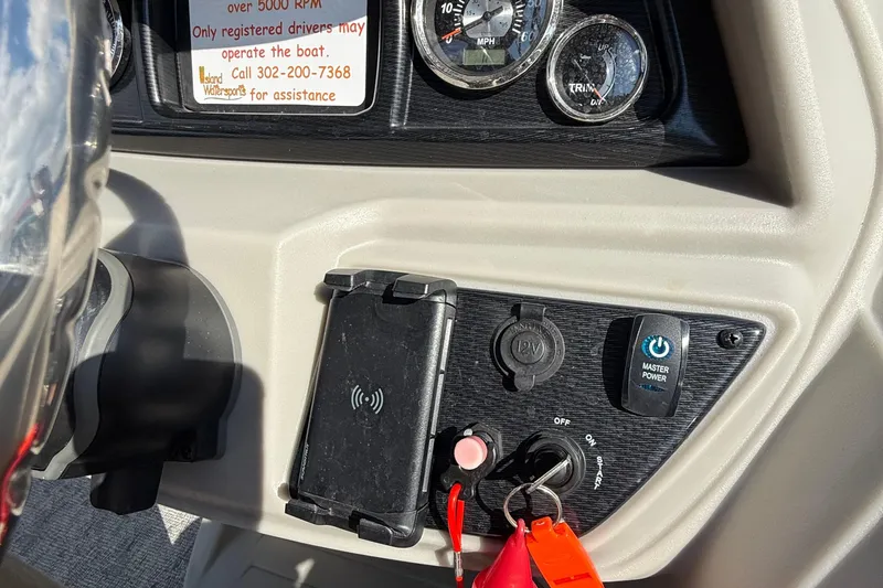 Slide: The Image of 2025 Berkshire 24CL 2.75 LE pontoon boat interior with seating and steering console. - 10